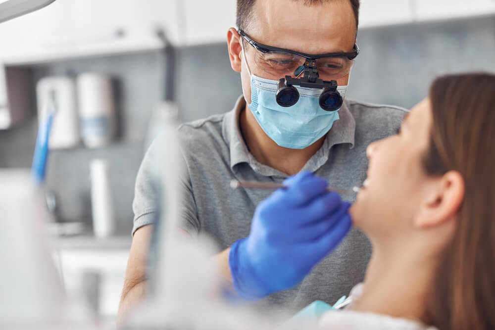 Modern dental surgery, face of a female doctor working on a patient