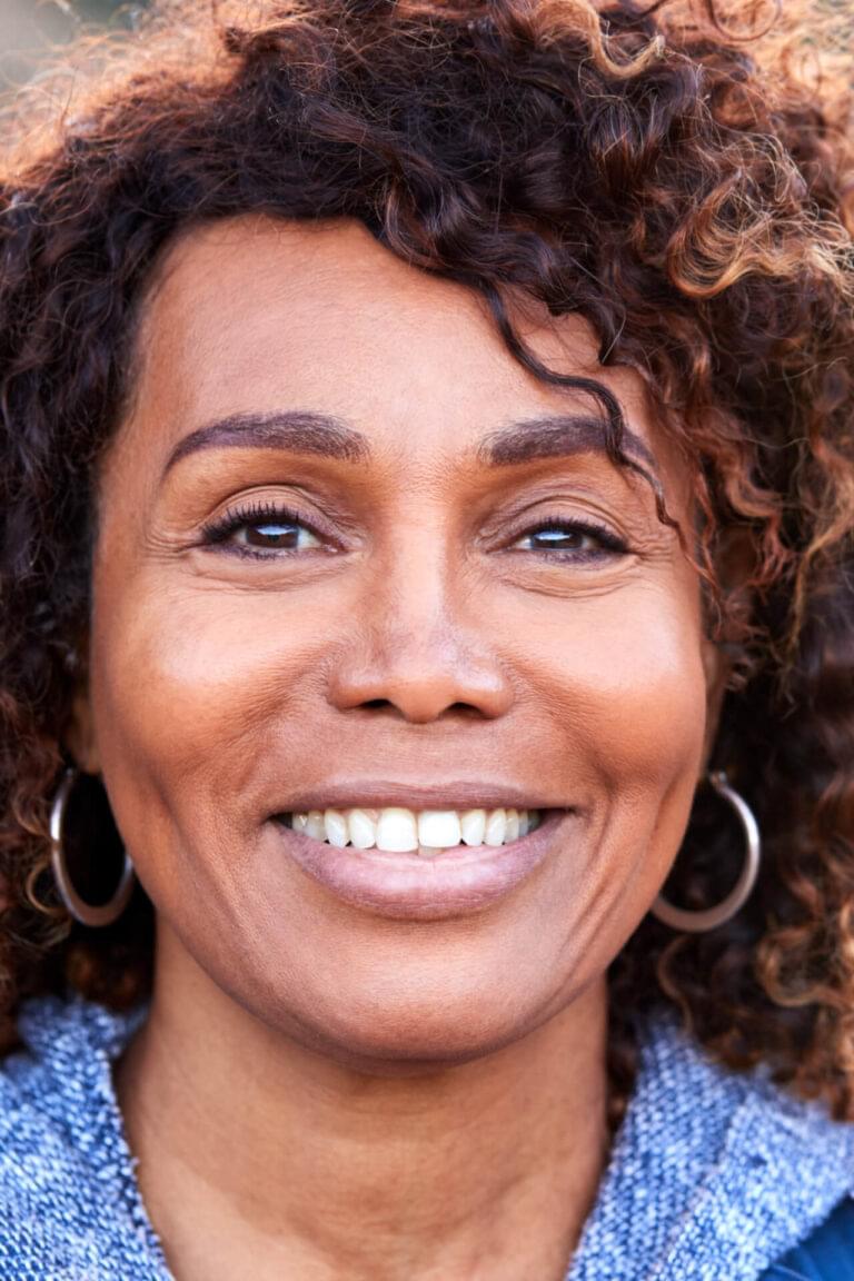 Portrait Of Smiling African American Senior Woman Outdoors In Countryside