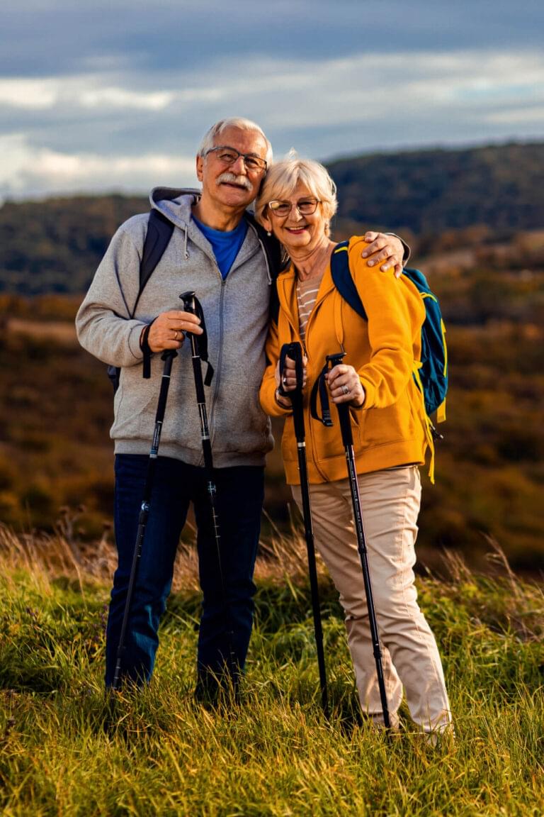 Portrait of active senior couple with backpacks hiking together