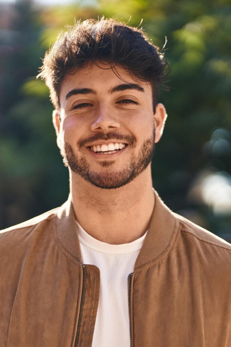 Young hispanic man smiling confident standing at park