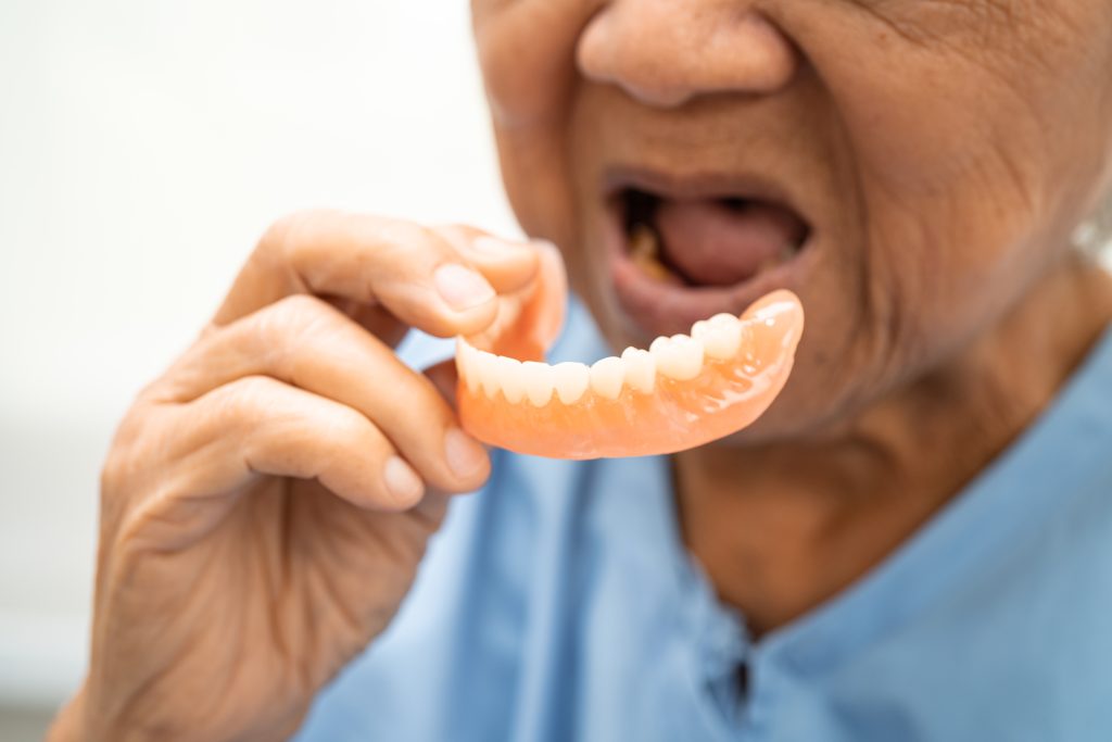 asian elderly woman patient holing to use denture